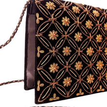 Load image into Gallery viewer, Side view of luxury black velvet evening clutch bag embroidered with antique gold geometric circle pattern with small flowers and embellished with genuine carnelian gemstones, formal clutch, gold and black zardozi purse.