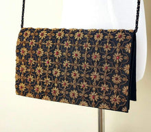 Load image into Gallery viewer, Black silk and copper clutch bag with garnets.
