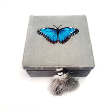 Load image into Gallery viewer, Blue morpho butterfly gift box on gray velvet BoutiqueByMariam.
