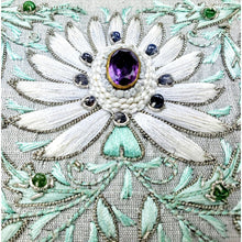 Load image into Gallery viewer, Embroidered white lotus flower with central cut amethyst stone and surrounding blue sapphire beads, zardozi embroidery, close up view.
