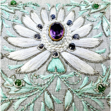 Load image into Gallery viewer, Embroidered white lotus flower with central cut amethyst stone and surrounding blue sapphire beads, zardozi embroidery, close up view.