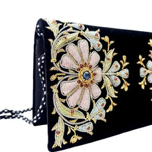 Load image into Gallery viewer, Side view of black velvet luxury evening clutch bag embroidered with two large flowers in pastel pink and blue colors and embellished with genuine gemstones, floral wedding clutch, black and pink zarozi purse.