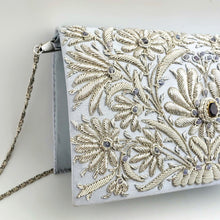 Load image into Gallery viewer, Side view of luxury wedding clutch bag in pale blue silk embroidered with silver all over floral pattern and embellished with central facet cut amethyst gemstone and aqua chalcedony gemstones, bridal purse, mother of the bride purse, blue and silver zardozi purse.