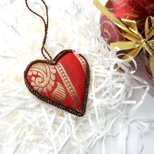 Load image into Gallery viewer, Hand embroidered red heart hanging ornament on red and gold brocade fabric, back view. 
