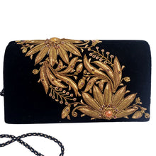Load image into Gallery viewer, Black velvet luxury evening clutch bag embroidered with two large flowers on the bias in antique gold color and embellished with genuine gemstones, floral wedding clutch, black and gold zardozi purse.