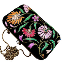 Load image into Gallery viewer, Black velvet hard case clutch embroidered with floral design, top view. 
