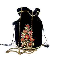 Load image into Gallery viewer, Hand embroidered black potli bag with red and gold flowers and inlaid with gemstones, zardozi potli bag.
