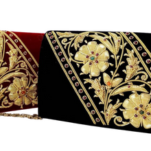 Load image into Gallery viewer, Side view of black velvet luxury evening clutch bag embroidered with large gold flowers on the bias and embellished with semi precious stones, floral wedding clutch, black and gold zardozi purse.