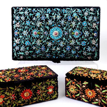 Load image into Gallery viewer, Three black velvet embroidered keepsake boxes, one with blue flowers, one with red flowers, one with orange flowers, inlaid with rubies. 
