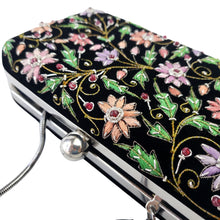 Load image into Gallery viewer, Embroidered black velvet hard case clutch embroidered with multicolor flowers, top view, BoutiqueByMariam.
