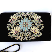 Load image into Gallery viewer, Luxury black velvet evening clutch bag embroidered with large central floral wreath in pastel blue and yellow colors and embellished with genuine gemstones, floral wedding clutch, black and multicolor zardozi purse.