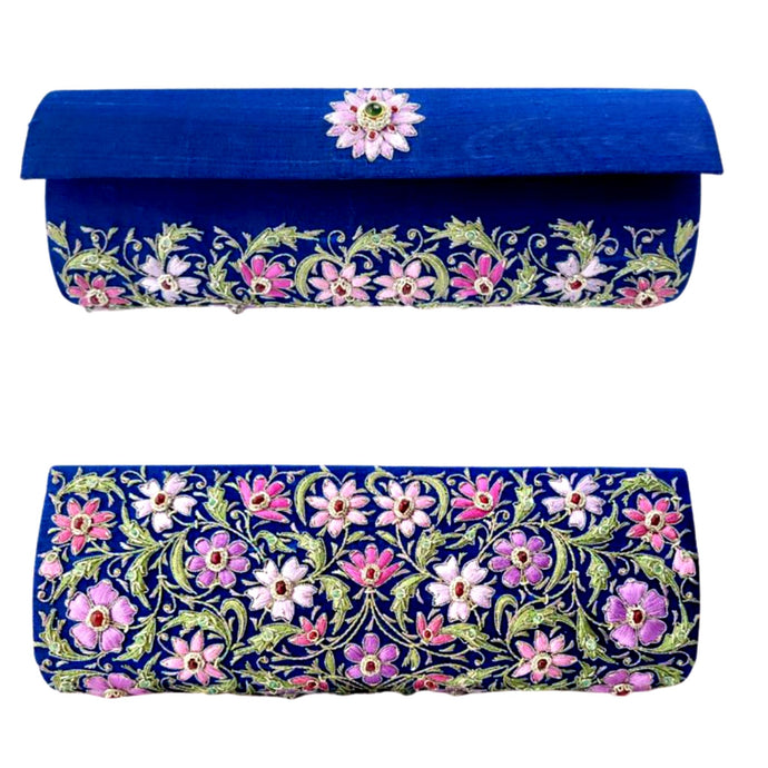 Marine-blue-silk-barrel-clutch-embroidered-front-and-back-with-lavender-flowers-and-embellished-with-rubies-and-emerald-gemstone.