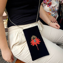 Load image into Gallery viewer, Hand embroidered floral crossbody phone sleeve embellished with gemstones, zardozi purse, shown on model.