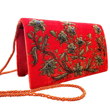 Load image into Gallery viewer, Side view of orange velvet luxury designer evening clutch bag embroidered with flowers in antique gold color and embellished with genuine gemstones, wedding clutch, orange and gold zardozi purse.