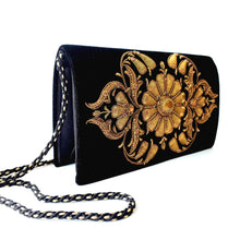 Load image into Gallery viewer, Side view of luxury black velvet evening clutch bag embroidered with large central flower in antique gold and embellished with genuine gemstones, floral wedding clutch, gold and black zardozi purse.