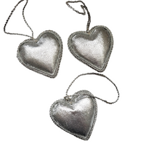 Load image into Gallery viewer, Set of three hanging silver heart ornaments, rear view.
