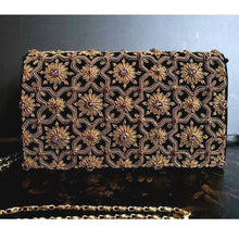 Load image into Gallery viewer, Luxury black velvet evening clutch bag embroidered with geometric pattern of antique gold eight sided star and flowers and embellished with amethyst and garnet gemstones, formal purse, black and gold zardozi purse.