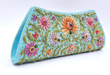 Load image into Gallery viewer, Turquoise blue clutch embroidered with multicolor flowers and embellished by star rubies, zardozi purse, side view. 
