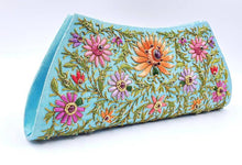 Load image into Gallery viewer, Turquoise blue clutch embroidered with multicolor flowers and embellished by star rubies, zardozi purse, side view.