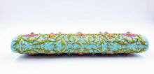 Load image into Gallery viewer, Turquoise blue clutch embroidered with multicolor flowers and embellished by star rubies, zardozi purse, bottom view. 
