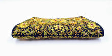 Load image into Gallery viewer, Black clutch embroidered with yellow flowers and embellished with rubies, bottom view.