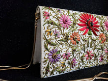 Load image into Gallery viewer, Ivory silk clutch bag embroidered with red and multicolor silk flowers with gold tone chain, zardozi evening bag, side view.