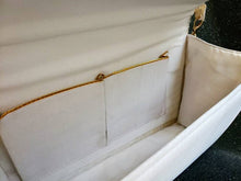 Load image into Gallery viewer, Ivory satin lining of ivory clutch bag with gold trim on two pockets.