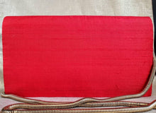 Load image into Gallery viewer, Red dupioni silk clutch bag with gold tone chain, back view.