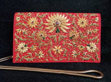 Load image into Gallery viewer, Gold and caramel colored silk flowers embroidered on vibrant red silk clutch embellished with star rubies, gold tone chain, zardozi purse.