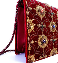 Load image into Gallery viewer, Burgundy velvet clutch bag embroidered with copper metallic flowers and embellished with semi precious stones, cord strap, zardozi evening bag, side view. 
