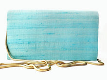 Load image into Gallery viewer, Turquoise blue silk clutch bag embroidered with multicolor silk flowers and embellished with star rubies, zardozi purse, rear view.