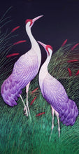 Load image into Gallery viewer, Embroidered bird wall art, two cranes with purple feathers standing in a grassy field embroidered on black velvet with an ornate border, framed, zardozi art.