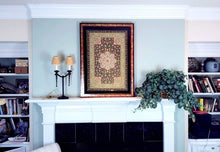 Load image into Gallery viewer, Statement large exclusive luxury hand embroidered silk floral tapestry with star rubies, framed zardozi jewel carpet wall art, hanging over fireplace in a room.
