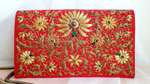 Load image into Gallery viewer, Gold and caramel colored silk flowers embroidered on vibrant red silk clutch embellished with star rubies, gold tone chain, zardozi purse.
