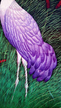 Load image into Gallery viewer, Embroidered bird silk wall art, two standing cranes with purple feathers embroidered on black velvet with an ornate border, framed, zardozi art, close up view of feathers.
