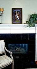 Load image into Gallery viewer, Framed embroidered bird tapestry, embroidered blue silk pheasant on black velvet with ornate border, zardozi art, shown in a room over a fireplace. 
