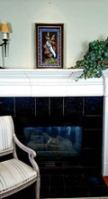 Load image into Gallery viewer, Framed embroidered bird tapestry, embroidered blue silk pheasant on black velvet with ornate border, zardozi art, shown in a room over a fireplace.