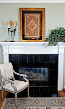 Load image into Gallery viewer, Large luxury hand embroidered red floral silk tapestry wall hanging with star rubies, zardozi jewel carpet wall art, framed, hanging over fireplace in a room.