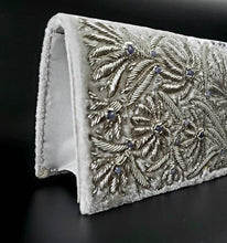 Load image into Gallery viewer, Bridal clutch in ivory velvet embroidered with silver lotus flowers and embellished with amethyst, zardozi evening bag, side view.