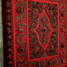 Load image into Gallery viewer, Hand embroidered Jewel carpet wall hanging, red flowers embroidered on burgundy red velvet, inlaid with agate stones, zardozi tapestry, side view.