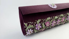Load image into Gallery viewer, Maroon purple zardozi embroidered silk clutch bag with all over purple and pink floral design and embellished with emerald and star rubies, side view.