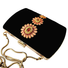 Load image into Gallery viewer, Black velvet hard case clutch embroidered with peach colored flowers, top view, BoutiqueByMariam.
