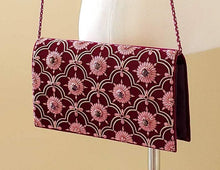 Load image into Gallery viewer, Burgundy and pink velvet handbag shown on model BoutiqueByMariam.
