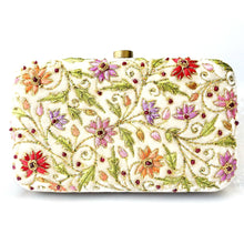 Load image into Gallery viewer, Luxury ivory velvet hard case clutch bag minaudiere hand embroidered with multicolor silk flowers and embellished with ruby gemstones, zardozi embroidery. 
