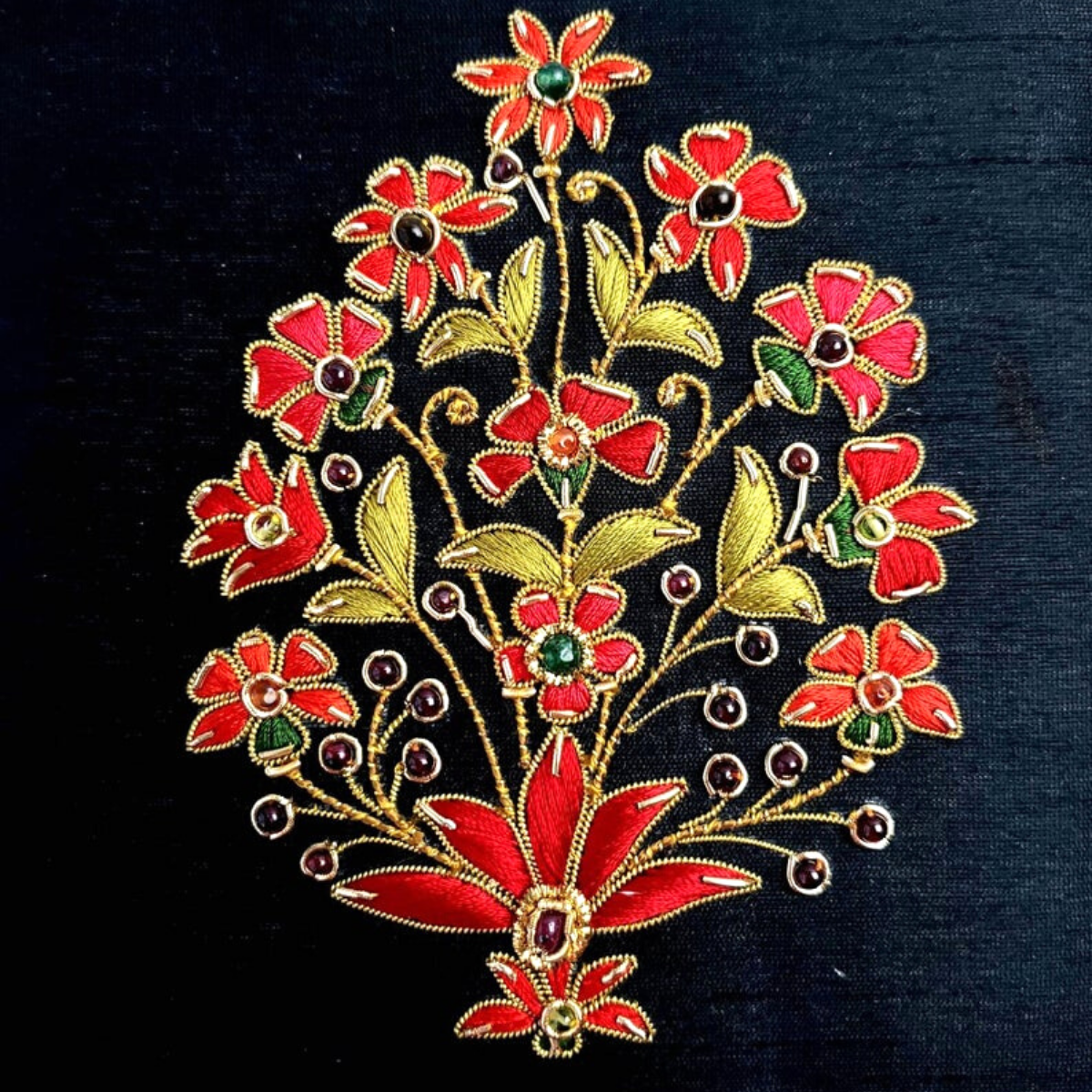 Hand embroidered red flowers on black silk decorative box, with semi precious stones, close up view. 