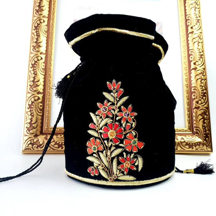 Black velvet potli bag embroidered with red and gold flowers, luxury bucket bag with zardozi embroidery. 