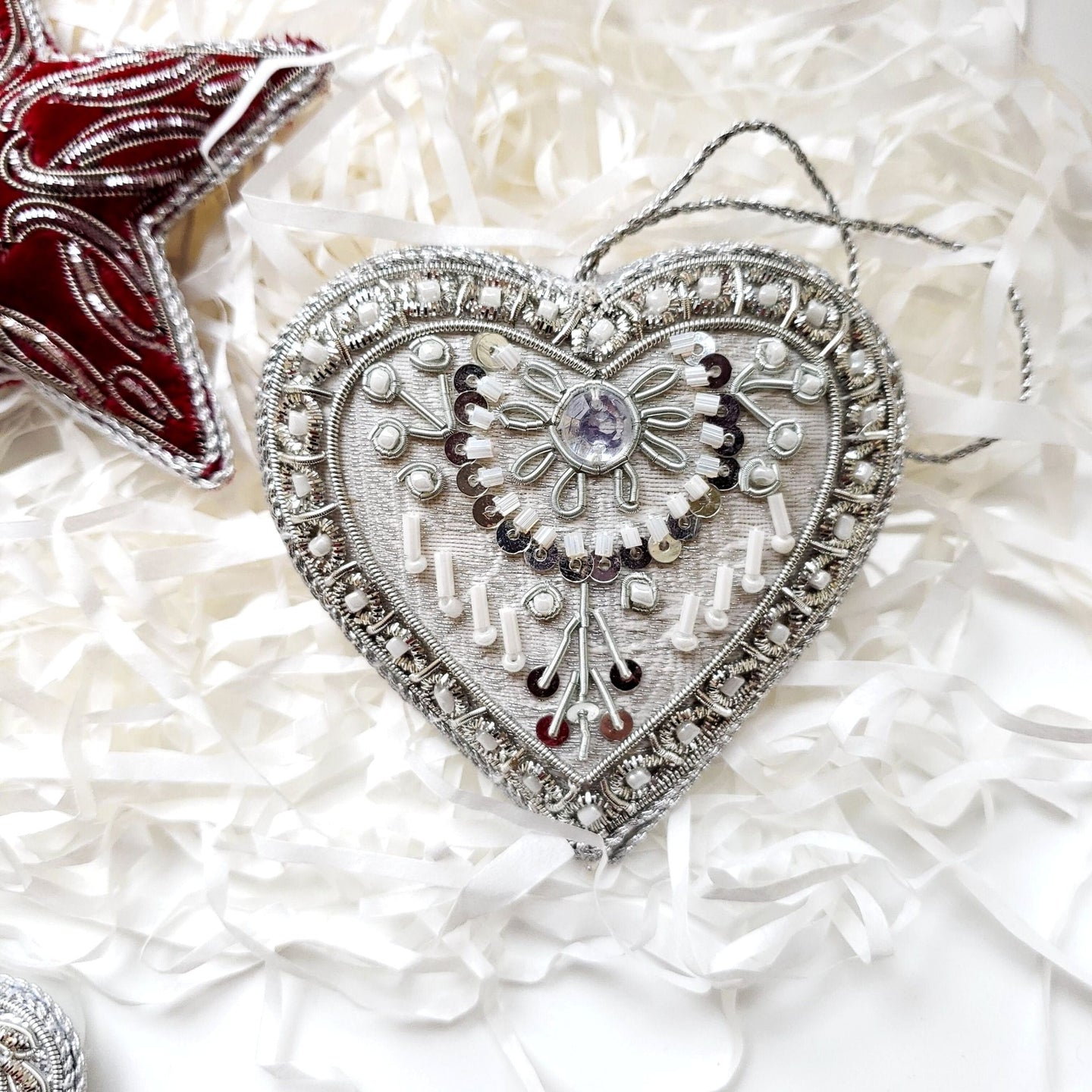Hand embroidered silver sequin and beaded silver heart hanging holiday ornament. 