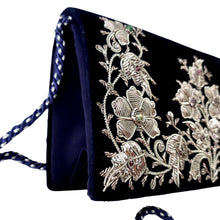 Load image into Gallery viewer, Navy blue velvet evening bag hand embroidered with silver flowers, side view. 
