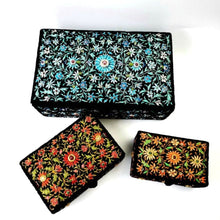 Load image into Gallery viewer, Three black velvet embroidered jewelry boxes, one with blue flowers, one with red flowers, one with orange flowers, inlaid with rubies.
