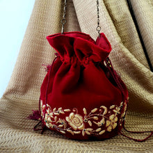 Load image into Gallery viewer, Indian wedding clutch bag in red velvet embroidered with gold flowers, zardozi embroidery. 
